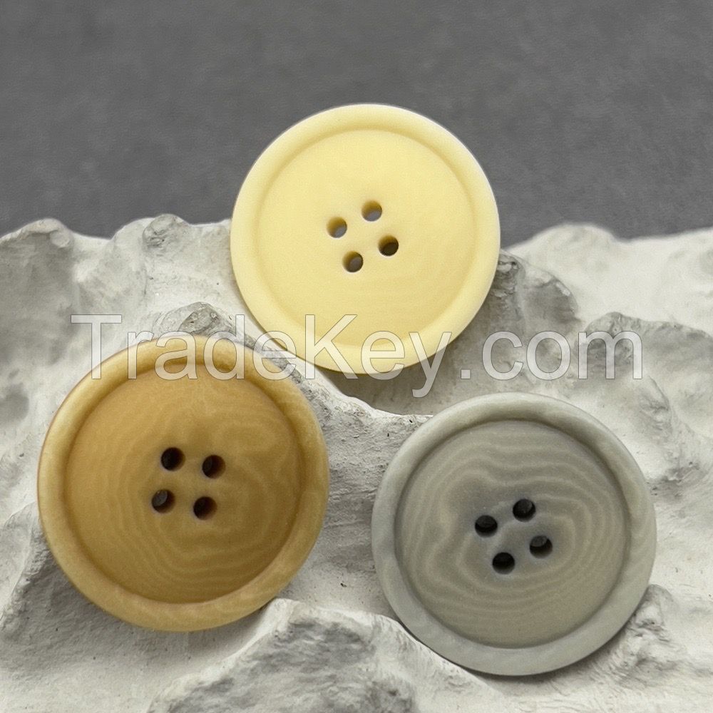 Soft colored corozo buttons in mild grey, yellow and brown