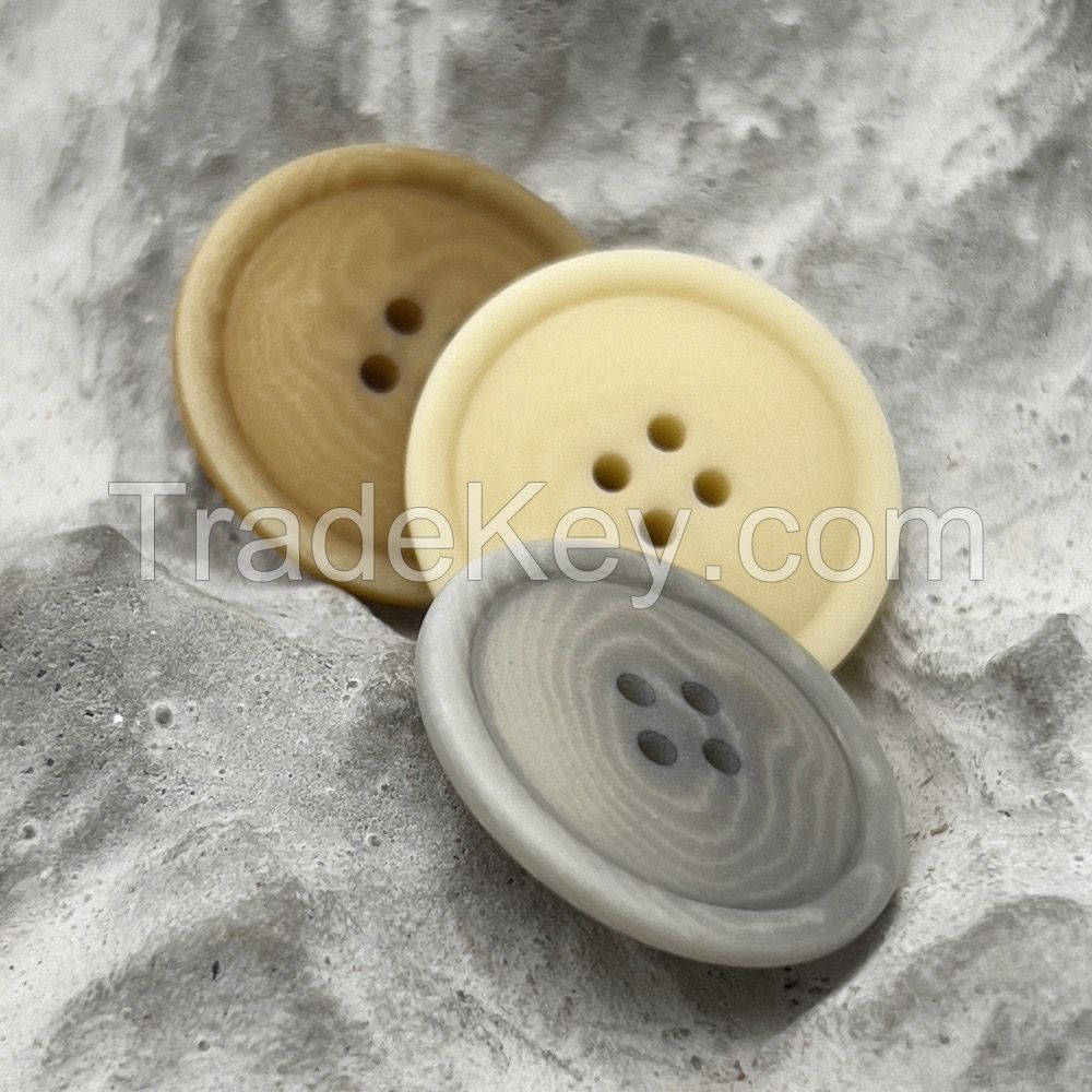 Soft colored corozo buttons in mild grey, yellow and brown