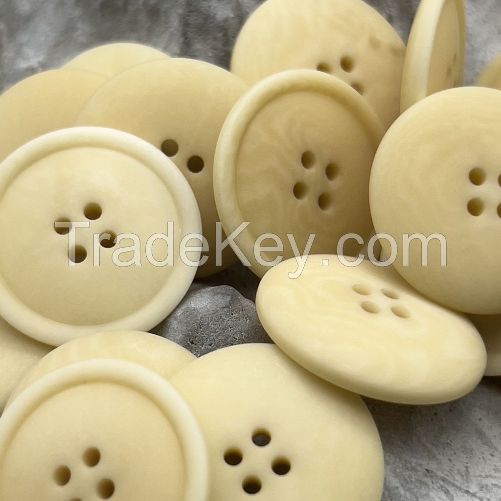 Soft colored corozo buttons in mild grey, yellow and brown