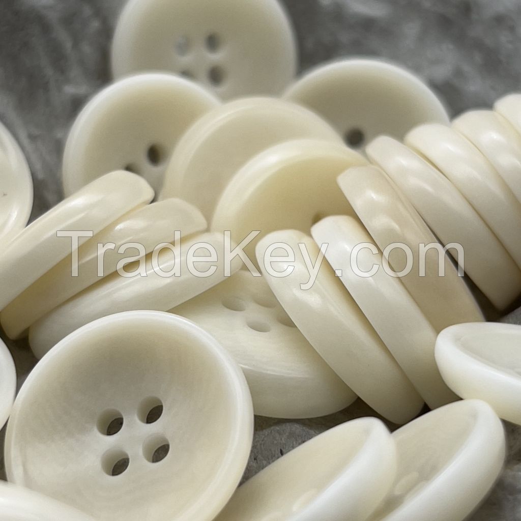 Bowl shape corozo buttons in white, orange, ginger, chesnut and black