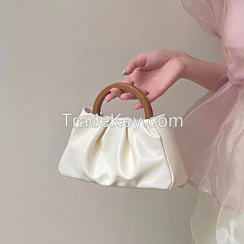 2022 Niche new female wrapped wooden handle pleated cloud small tote single shoulder slant mini bag